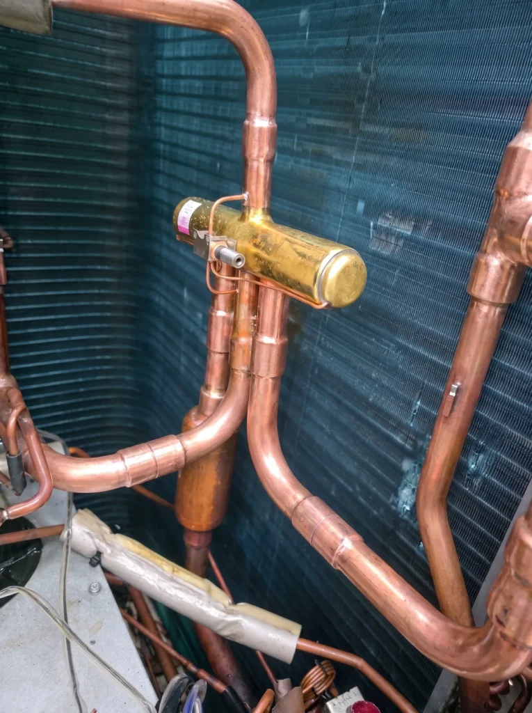Copper pipework and brass expansion valve on an air conditioning system
