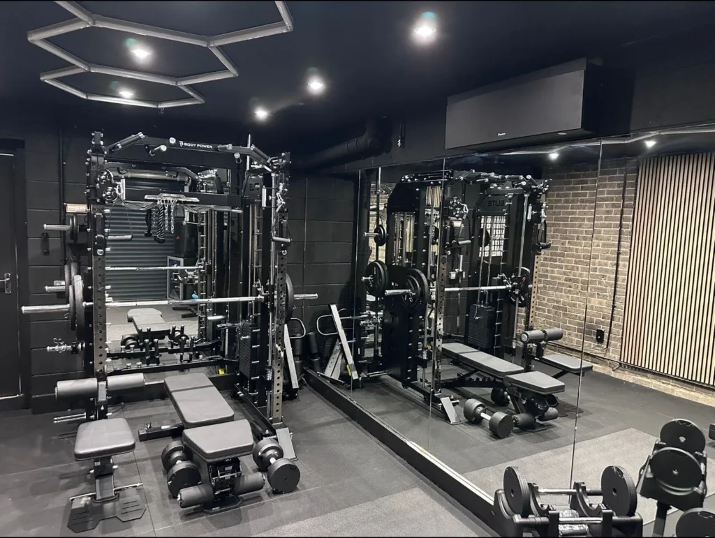 Black air conditioning unit installed in a home gym